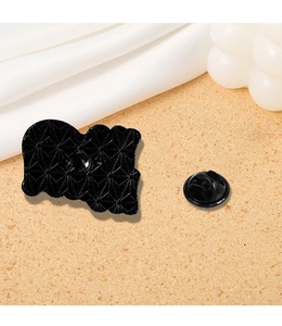 Macro view of black metal brooch back with diamond texture and butterfly clutch