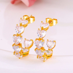 Luxury gold heart stud earrings with sparkling white zircon crystals in a curved design