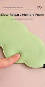 Close-up of fingers pressing light green memory foam sleep mask showing slow rebound effect