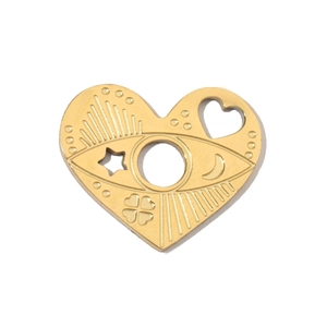 Macro view of gold heart pendant featuring engraved eye, moon and star celestial patterns