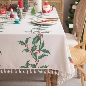 Christmas tablecloth with holly berry print and fringe tassels for holiday dining