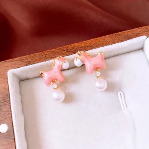 Pink enamel pony earrings with 18K gold plating and pearls in a jewelry box