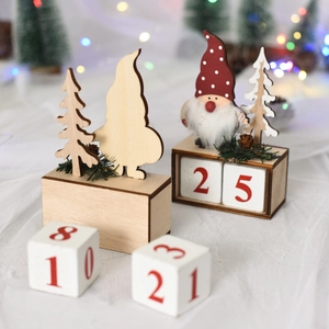 Close-up of wooden Christmas countdown calendar blocks with red numbers and gnome figure