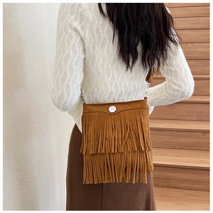 Detailed view of long fringes and suede texture on the brown crossbody bag for women