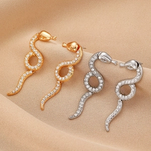 Sparkling snake-shaped earrings in gold and silver finish with pavé set rhinestones