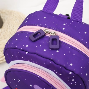 Detail of rocket backpack showing purple starry nylon fabric and pink zipper trim