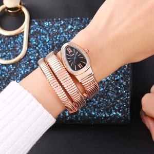 Close-up of rose gold snake bracelet watch with black dial and crystal bezel