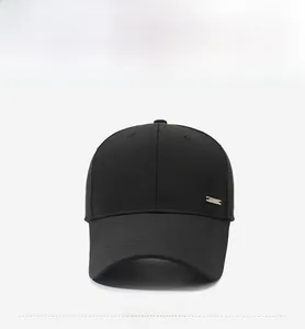 Detail view of the black baseball cap showing the side metal buckle and cotton twill fabric