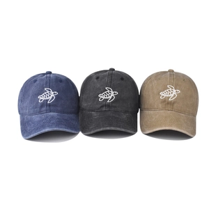 Washed cotton baseball caps with embroidered turtle designs in navy, black, and khaki