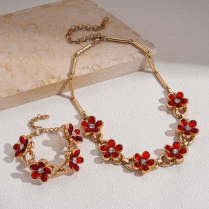 Vintage gold chain necklace with red glass flowers and sparkling crystal accents