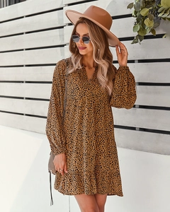 Close-up of a leopard print long sleeve maxi dress with a brown felt hat and sunglasses