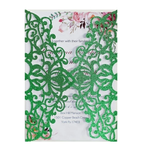 Detail of dark green glitter laser-cut wedding invitation with floral insert card