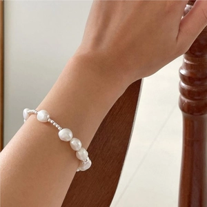Detailed view of Baroque freshwater pearl bracelet with silver beads on a wrist