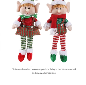 Detail of Christmas elf dolls with striped socks and plaid skirt on a white background