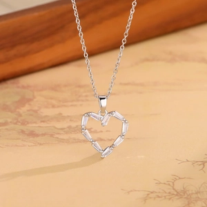 Close-up of heart pendant necklace featuring rectangular cubic zirconia in silver finish