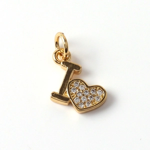 Close-up of a gold-plated letter I and heart pendant set with sparkling zircon stones