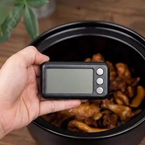 Magnetic digital kitchen timer with LCD display and black rectangular case shown in a cozy kitchen