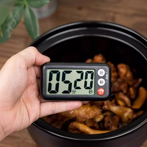 Magnetic digital kitchen timer with LCD display and black rectangular case shown in a cozy kitchen
