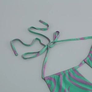 Detail of green and purple zebra print halter dress showing fine mesh texture and tie strap