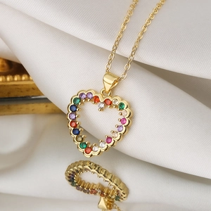 Elegant gold heart pendant necklace and ring set with colorful zircon on white silk