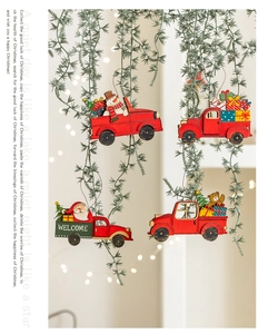 Detail of red wooden Christmas car ornaments with Santa and bear on pine branches