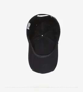 Detail view of cotton baseball cap interior with 100% cotton label and reinforced seams