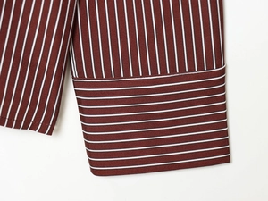 Macro shot of striped shirt cuffs featuring fine vertical patterns and high-quality stitching