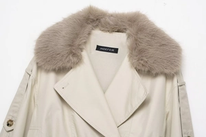 Detail of short waterproof windbreaker featuring a plush grey faux fur collar and brand label