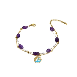 Ocean style gold double-layer anklet with purple stones and whale charm on white background