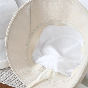 Close-up of beige sun hat interior showing inner lining and sweatband stitching