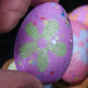 Detail of purple Easter egg ornament featuring green glitter flowers and colorful sequins