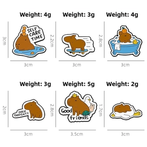 Detailed view of six cartoon Capybara enamel pins showing dimensions and weights