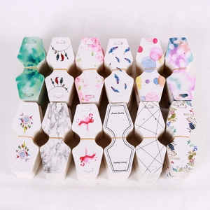 Macro view of patterned paper jewelry display cards with floral and geometric motifs