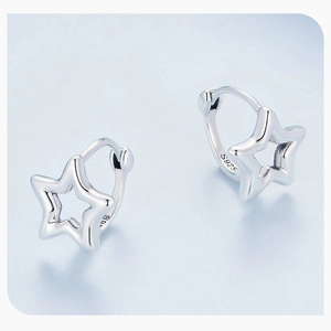 Macro shot of S925 sterling silver star-shaped earrings showing the hallmark stamp