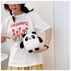 Close-up of a cute plush panda crossbody bag with a golden chain strap on a model