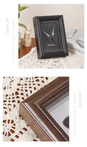 Close-up of vintage deep wood frame showing 3D butterfly specimen and grain texture