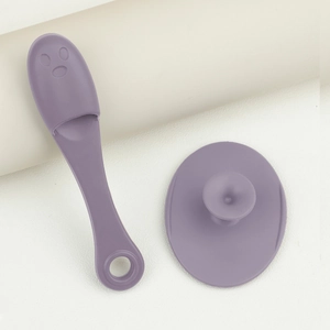Detailed view of purple silicone face cleanser brush and applicator with suction base