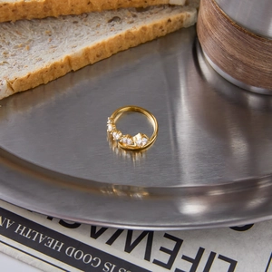 Classic 18K gold stainless steel open ring with round white zircon on a tray