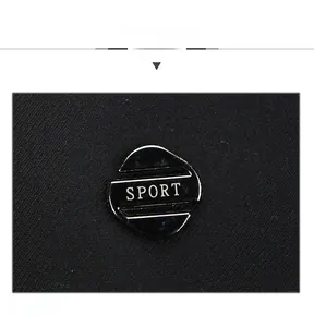 Close-up of black fabric texture with a metallic 'SPORT' emblem on a men's baseball cap