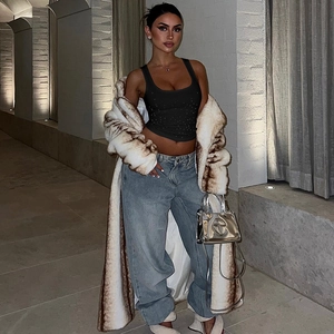 Fashion street look με μαύρο camisole top με στρας και μακρύ παλτό από συνθετική γούνα