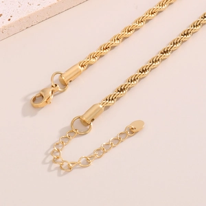 Detailed shot of 18K gold plated stainless steel twist chain with lobster clasp and tag