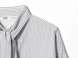 Detail of vertical black and white striped poplin shirt neckline with tie-up scarf and label
