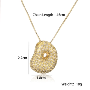 Detailed view of gold plated necklace with donut pendant and size measurement markings
