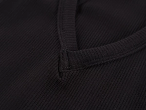 Macro shot of V-neckline stitching on a black ribbed knit camisole top