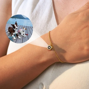 Macro shot of gold projection bracelet with zircon stones showing custom pet photo display