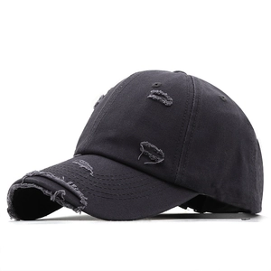 Vintage distressed black baseball cap with ripped details and worn-out streetwear design