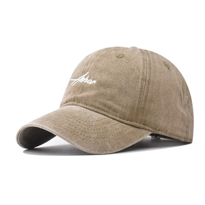Detail of khaki washed canvas baseball cap featuring white Fisher embroidery and fine stitching