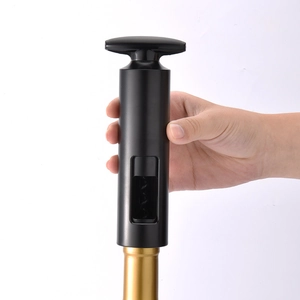 Manual black cylindrical wine opener being used on a bottle neck, minimalist tool style