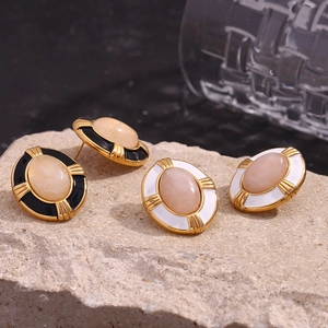 Macro shot of 18K gold plated oval natural stone earrings with a vintage enamel finish
