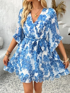 Close-up of blue floral print V-neck dress with ruffle sleeves and tied waist detail